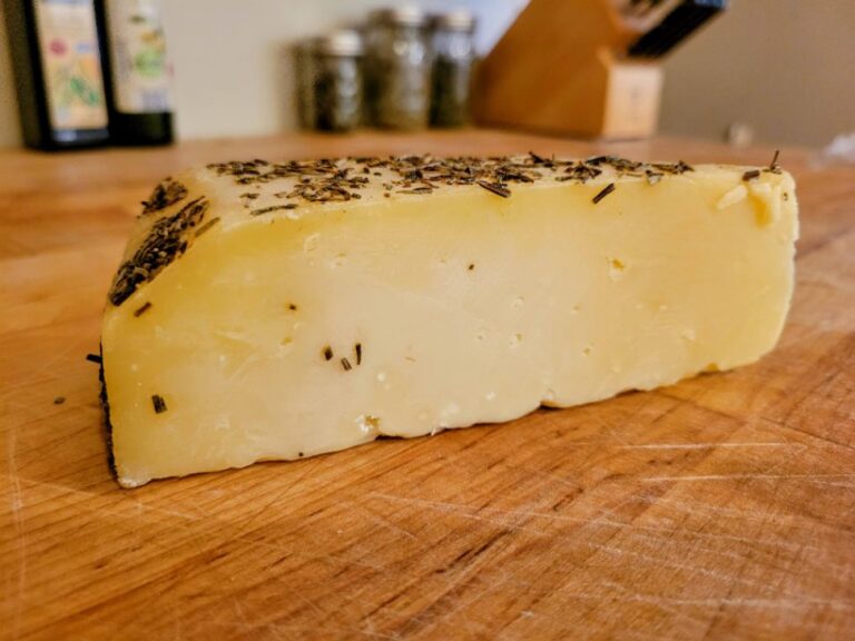 Asiago cheese block on butcher block