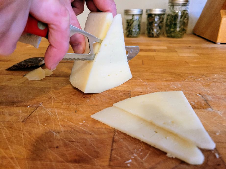 Cutting Manchego cheese into wedges